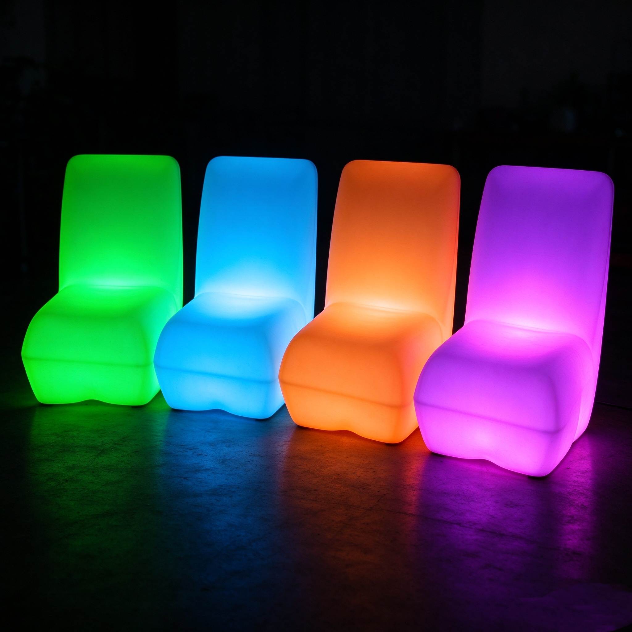 Four LED rotomolded lounge chairs glowing in green, blue, orange and purple, showing the multi-color lighting function for outdoor bars and parties.